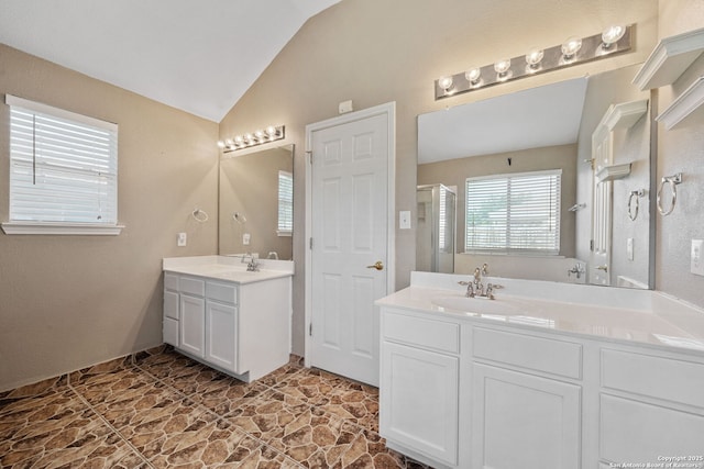 9511 Autumn Run, Converse, TX 78109 - bathroom featuring vaulted ceiling, two vanities, and a shower with door
