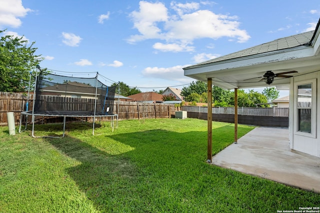 9511 Autumn Run, Converse, TX 78109 - fenced backyard with a trampoline, a patio, and ceiling fan