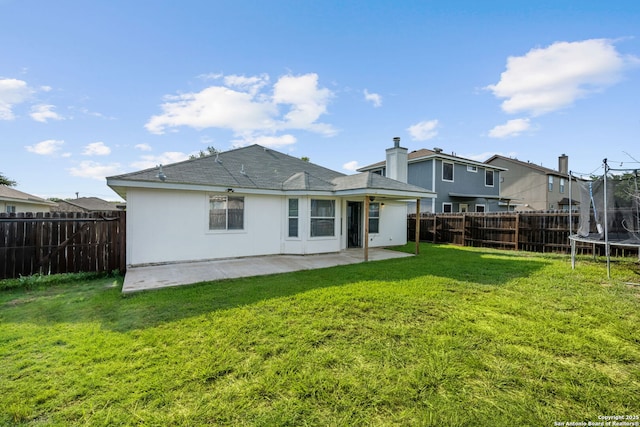 9511 Autumn Run, Converse, TX 78109 - back of house featuring a trampoline, a patio, and a fenced backyard