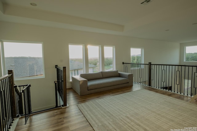 137 Mescalero, Boerne, TX 78006 - sitting room with an upstairs landing, wood finished floors, and a tray ceiling