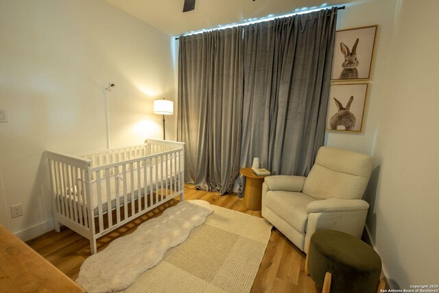 137 Mescalero, Boerne, TX 78006 - bedroom with wood finished floors and a nursery area