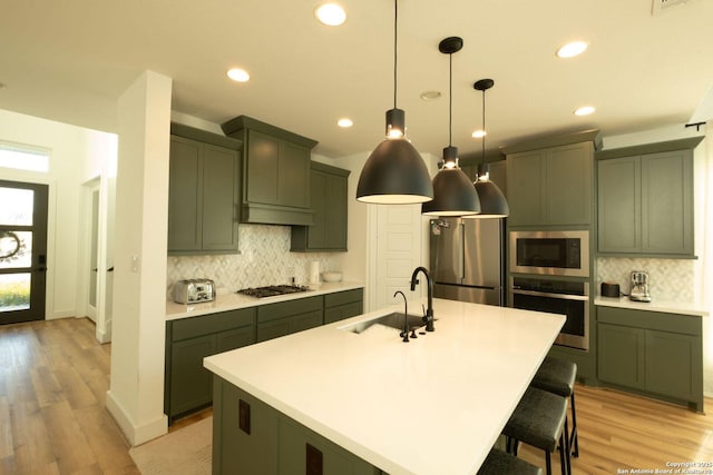 137 Mescalero, Boerne, TX 78006 - kitchen with appliances with stainless steel finishes, green cabinets, backsplash, recessed lighting, and light countertops