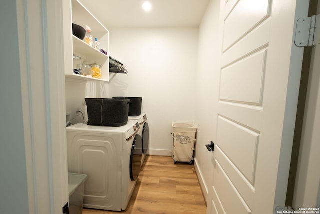 137 Mescalero, Boerne, TX 78006 - laundry area with washing machine and clothes dryer, light wood-type flooring, and recessed lighting