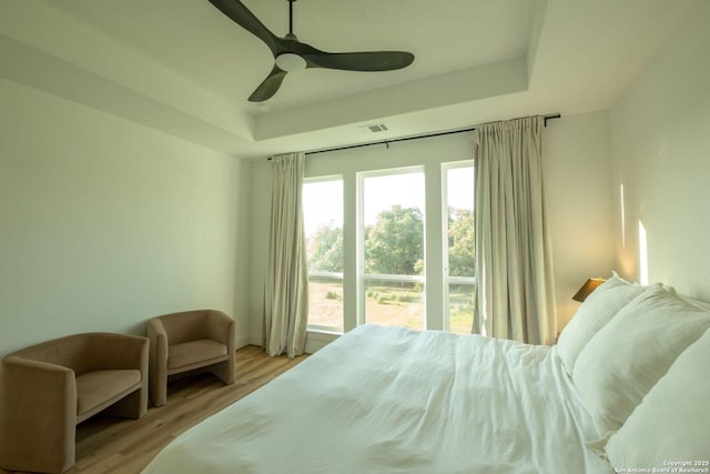 137 Mescalero, Boerne, TX 78006 - bedroom featuring a tray ceiling, wood finished floors, and ceiling fan