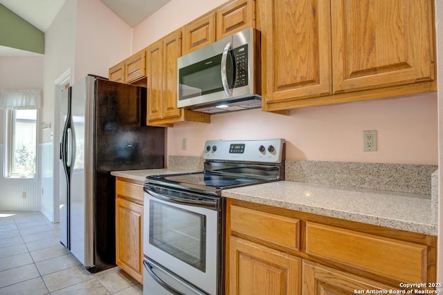 201 Cibolo Xing, Boerne, TX 78006 - kitchen featuring stainless steel appliances, light tile patterned flooring, and light stone counters