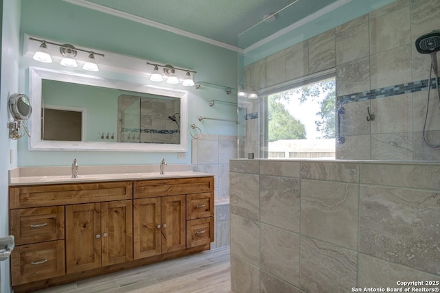 201 Cibolo Xing, Boerne, TX 78006 - bathroom with crown molding, walk in shower, double vanity, and wood finished floors