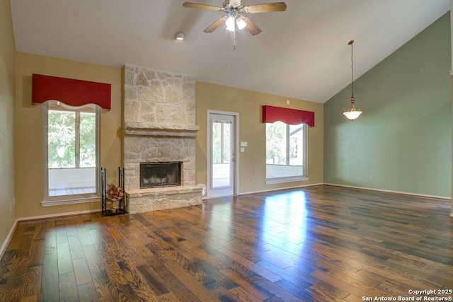 201 Cibolo Xing, Boerne, TX 78006 - unfurnished living room with hardwood / wood-style floors, a stone fireplace, ceiling fan, and high vaulted ceiling