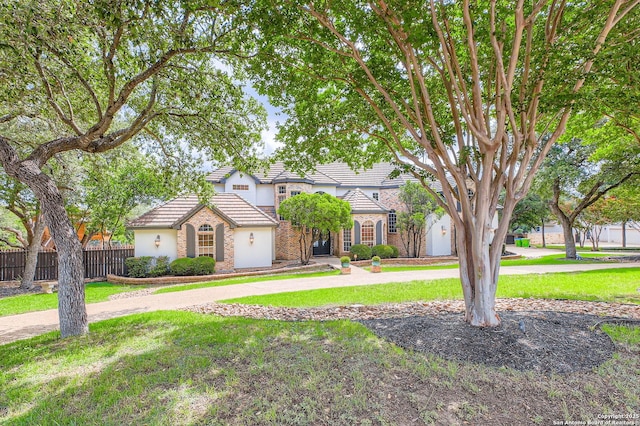 342 Candelaria, Helotes, TX 78023 - view of front of home featuring a tile roof, stucco siding, stone siding, and curved driveway