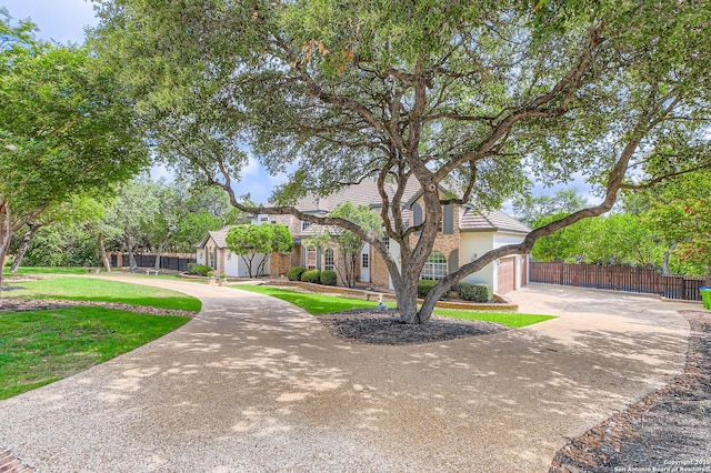342 Candelaria, Helotes, TX 78023 - view of property hidden behind natural elements featuring curved driveway, stucco siding, a garage, and a tiled roof