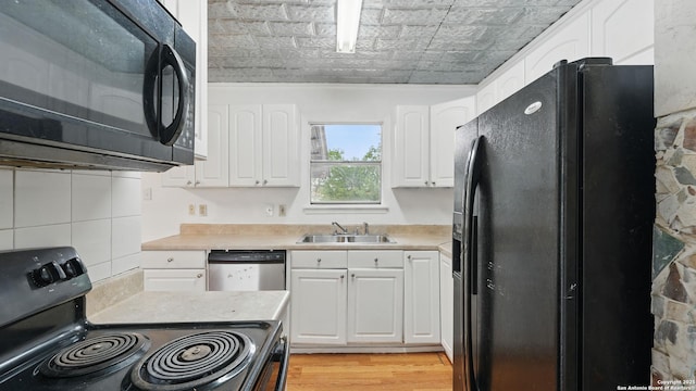 1029 Valley Frg, Schertz, TX 78154 - kitchen with black appliances, an ornate ceiling, white cabinets, light countertops, and light wood finished floors