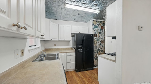 1029 Valley Frg, Schertz, TX 78154 - kitchen featuring black fridge, white cabinetry, light wood-type flooring, light countertops, and an ornate ceiling