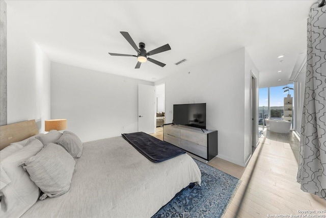 313 17th Unit, Austin, TX 78701 - bedroom with light wood finished floors and ceiling fan