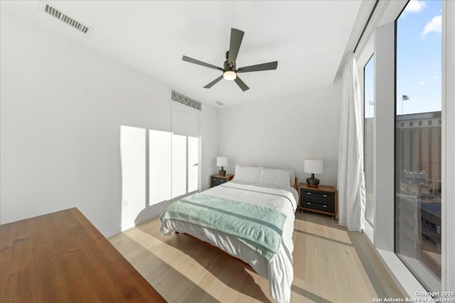 313 17th Unit, Austin, TX 78701 - bedroom with light wood finished floors and ceiling fan