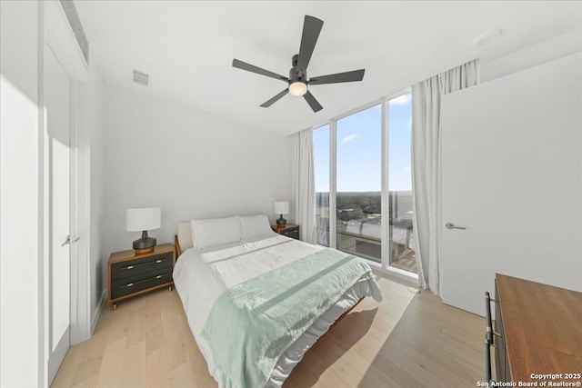 313 17th Unit, Austin, TX 78701 - bedroom featuring light wood-style floors, access to outside, a wall of windows, and ceiling fan