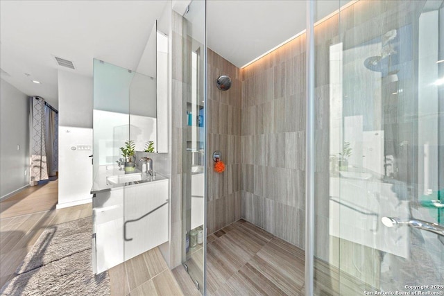 313 17th Unit, Austin, TX 78701 - bathroom featuring vanity and a shower stall