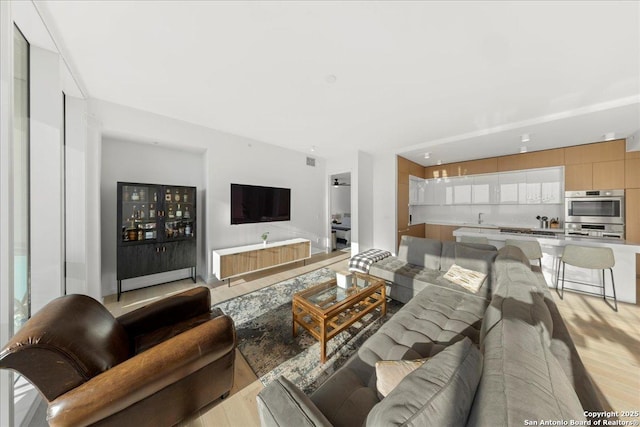 313 17th Unit, Austin, TX 78701 - living area featuring light wood-style floors