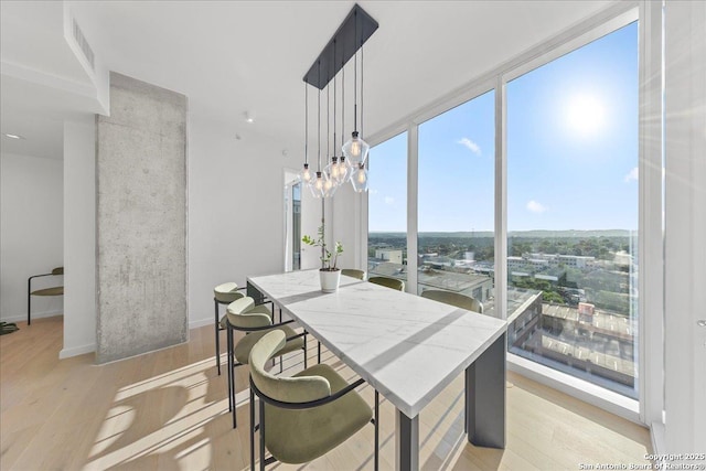 313 17th Unit, Austin, TX 78701 - dining space with light wood-style floors and a chandelier