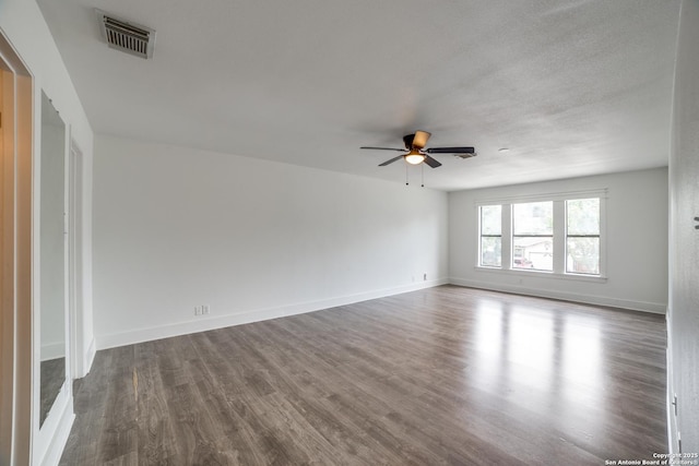 7711 Chatsworth, San Antonio, TX 78250 - empty room featuring ceiling fan and dark wood-type flooring