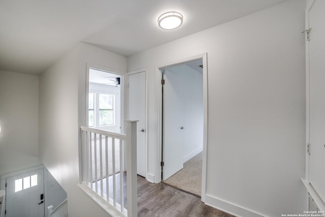 7711 Chatsworth, San Antonio, TX 78250 - hall with wood finished floors and an upstairs landing