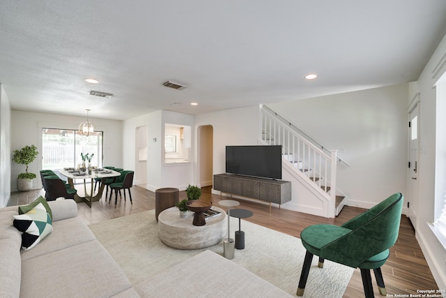 7711 Chatsworth, San Antonio, TX 78250 - living area featuring arched walkways, stairway, wood finished floors, and recessed lighting
