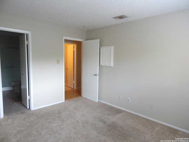 4119 Medical Unit 304F, San Antonio, TX 78229 - unfurnished bedroom with carpet and a textured ceiling