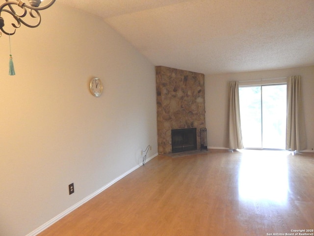 4119 Medical Unit 304F, San Antonio, TX 78229 - unfurnished living room featuring light wood-type flooring, a large fireplace, and lofted ceiling