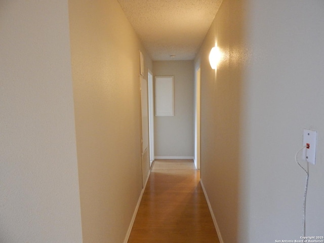 4119 Medical Unit 304F, San Antonio, TX 78229 - corridor with wood finished floors and a textured ceiling