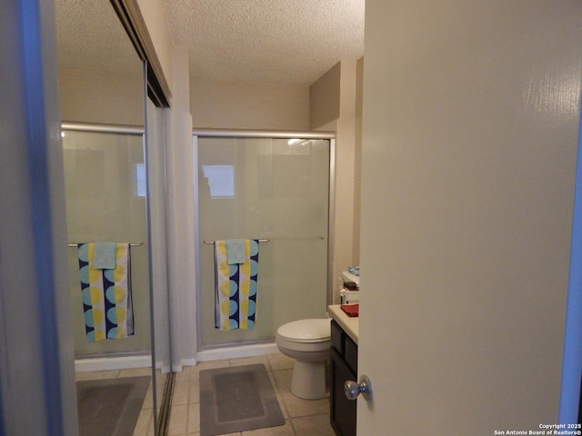 4119 Medical Unit 304F, San Antonio, TX 78229 - bathroom with tile patterned floors, a stall shower, a textured ceiling, and vanity