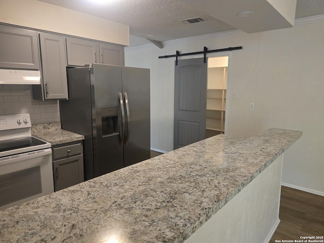 5214 King George, San Antonio, TX 78229 - kitchen with stainless steel fridge with ice dispenser, electric range, under cabinet range hood, dark wood finished floors, and gray cabinets