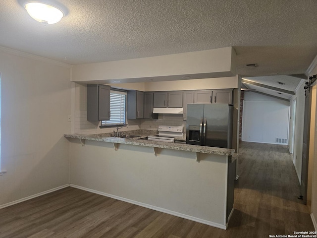 5214 King George, San Antonio, TX 78229 - kitchen with electric range, gray cabinetry, under cabinet range hood, dark wood-type flooring, and a textured ceiling