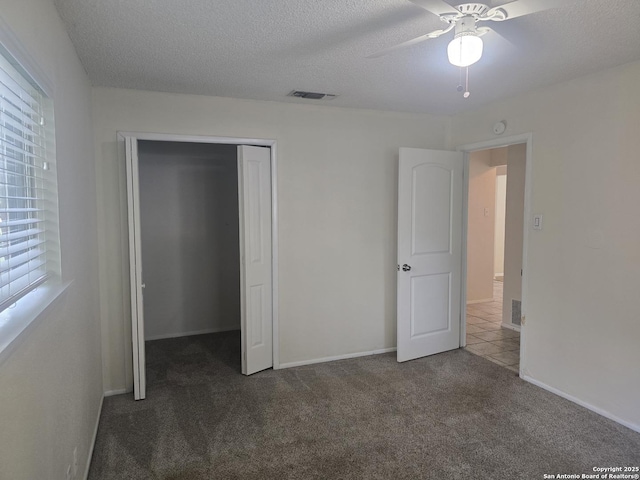 5214 King George, San Antonio, TX 78229 - unfurnished bedroom with carpet floors, a closet, a textured ceiling, and a ceiling fan