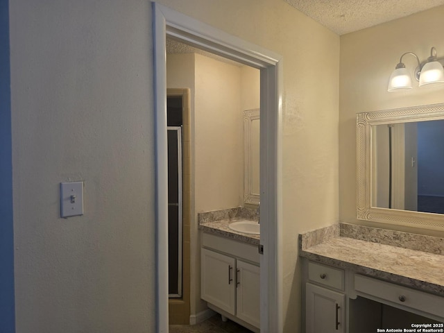 5214 King George, San Antonio, TX 78229 - bathroom with a stall shower, vanity, and a textured ceiling