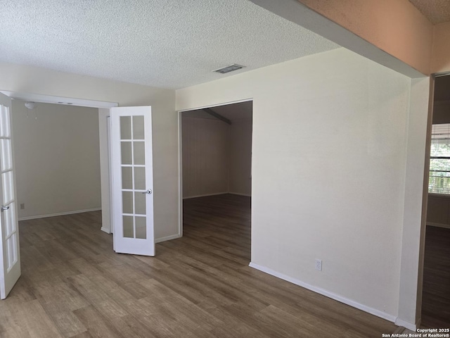5214 King George, San Antonio, TX 78229 - spare room featuring wood finished floors, a textured ceiling, and french doors