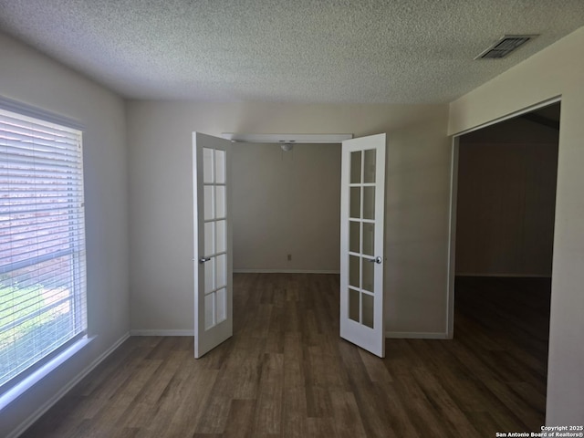 5214 King George, San Antonio, TX 78229 - empty room with french doors, wood finished floors, and a textured ceiling