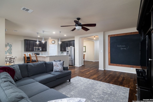 401 Canterbury, Cibolo, TX 78108 - living area featuring dark wood-style floors, a ceiling fan, arched walkways, and recessed lighting
