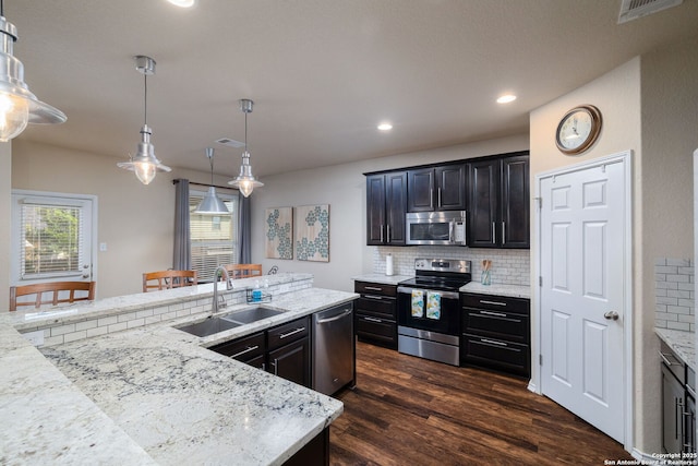 401 Canterbury, Cibolo, TX 78108 - kitchen featuring stainless steel appliances, tasteful backsplash, dark wood-style flooring, recessed lighting, and light stone countertops