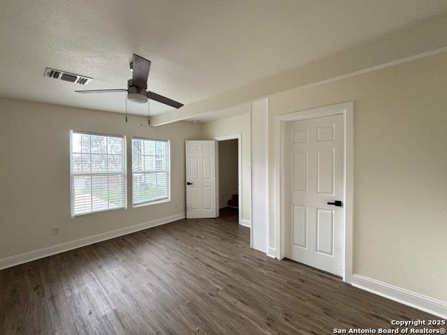 1014 Montana, San Antonio, TX 78203 - unfurnished bedroom featuring dark wood-type flooring and ceiling fan