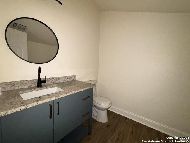 1014 Montana, San Antonio, TX 78203 - bathroom with wood finished floors and vanity