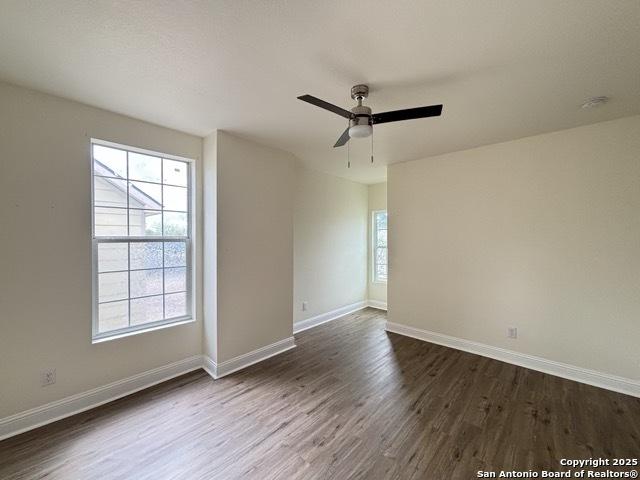 1014 Montana, San Antonio, TX 78203 - empty room with dark wood-style flooring, plenty of natural light, and a ceiling fan