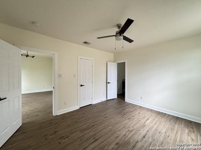 1014 Montana, San Antonio, TX 78203 - unfurnished bedroom with dark wood finished floors and ceiling fan