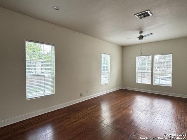 1014 Montana, San Antonio, TX 78203 - empty room with dark wood-style floors, healthy amount of natural light, and ceiling fan