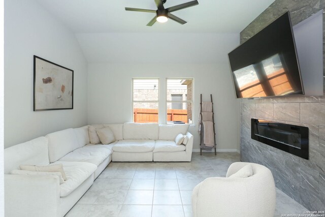 2863 Tortuga Verde, San Antonio, TX 78245 - living area featuring a ceiling fan, vaulted ceiling, light tile patterned floors, and a fireplace