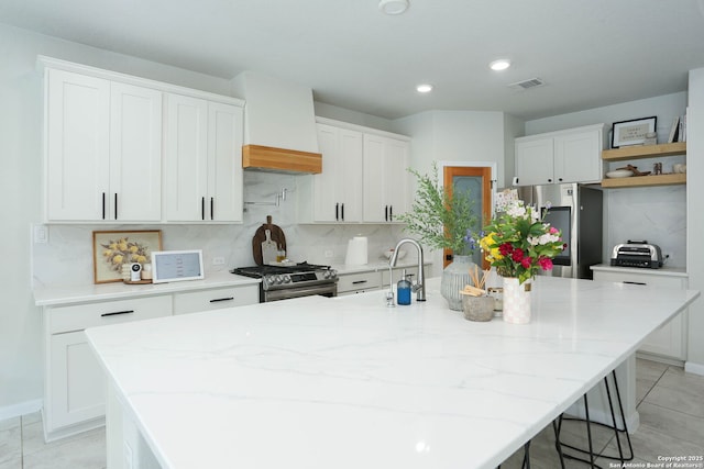 2863 Tortuga Verde, San Antonio, TX 78245 - kitchen featuring appliances with stainless steel finishes, an island with sink, backsplash, white cabinets, and recessed lighting