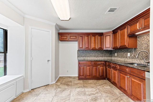 3410 Lone Valley St, San Antonio, TX 78247 - kitchen with decorative backsplash, ornamental molding, dark stone countertops, and brown cabinets