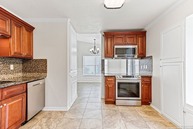 3410 Lone Valley St, San Antonio, TX 78247 - kitchen with appliances with stainless steel finishes, crown molding, a chandelier, dark stone countertops, and tasteful backsplash