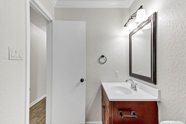 3410 Lone Valley St, San Antonio, TX 78247 - bathroom featuring ornamental molding, vanity, a textured wall, and wood finished floors
