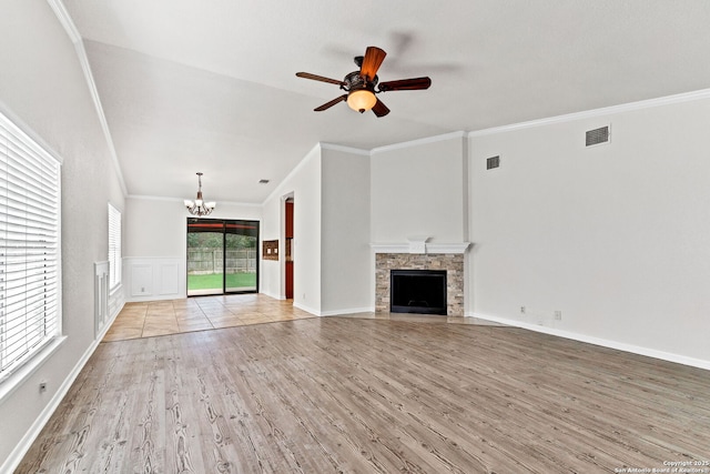 3410 Lone Valley St, San Antonio, TX 78247 - unfurnished living room with a chandelier, wood finished floors, crown molding, ceiling fan, and a stone fireplace