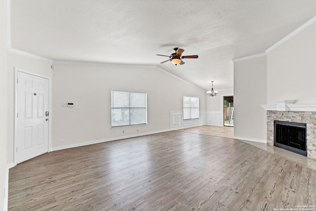 3410 Lone Valley St, San Antonio, TX 78247 - unfurnished living room with a chandelier, a ceiling fan, wood finished floors, ornamental molding, and a fireplace