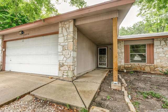 14410 Briarberry, San Antonio, TX 78247 - view of exterior entry with stone siding, a garage, and driveway