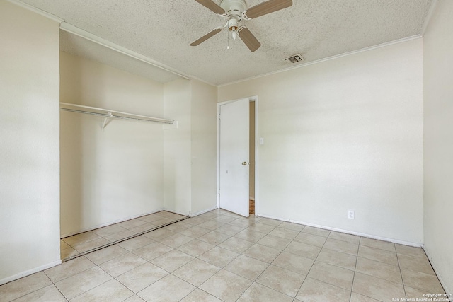 14410 Briarberry, San Antonio, TX 78247 - unfurnished bedroom featuring a textured ceiling, a closet, ceiling fan, crown molding, and tile patterned flooring